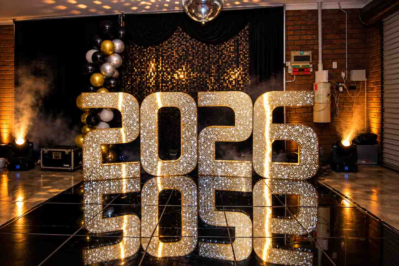 Gold and black luxury event styling with illuminated numbers